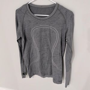 LuluLemon long sleeve shirt, gray, size 8-10 with thumb holes in the sleeve.